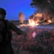 Photo of an Israeli soldier standing next to a burning bus