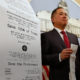Photo of Assemblyman Phil Ting of San Francisco with a long paper receipt