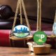 Illustration of scales of justice with city of Fresno and Measure P logos