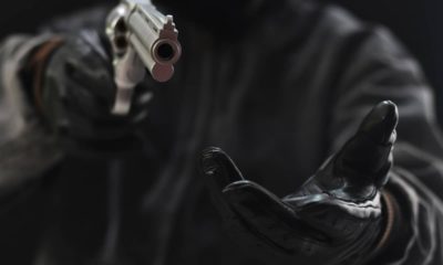 Photo of armed robber pointing a gun