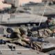 Photo of Israeli soldiers working on their tanks