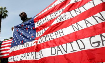 Photo of Malaki Seku holding an American flag