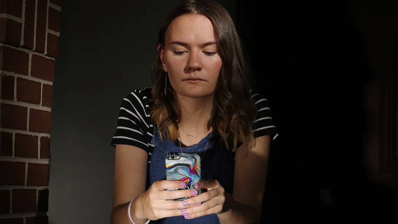 Photo of Rachel Wilson looking at her phone
