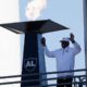 Photo of Cliff Branch lighting a memorial flame in honor of Al Davis.
