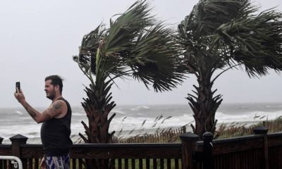 Photo of a man taking photos of waves crashing in Myrtle Beach