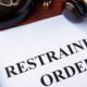 Photo of a restraining order on a desk with a gavel