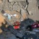 Photo of Palestinians sitting amid rubble