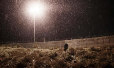 Photo of a U.S. Border Protection officer standing in the rain