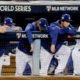 Photo of members of the Los Angeles Dodgers watching the Houston Astros celebrate their win in Game 7 of baseball's World Series in Los Angeles