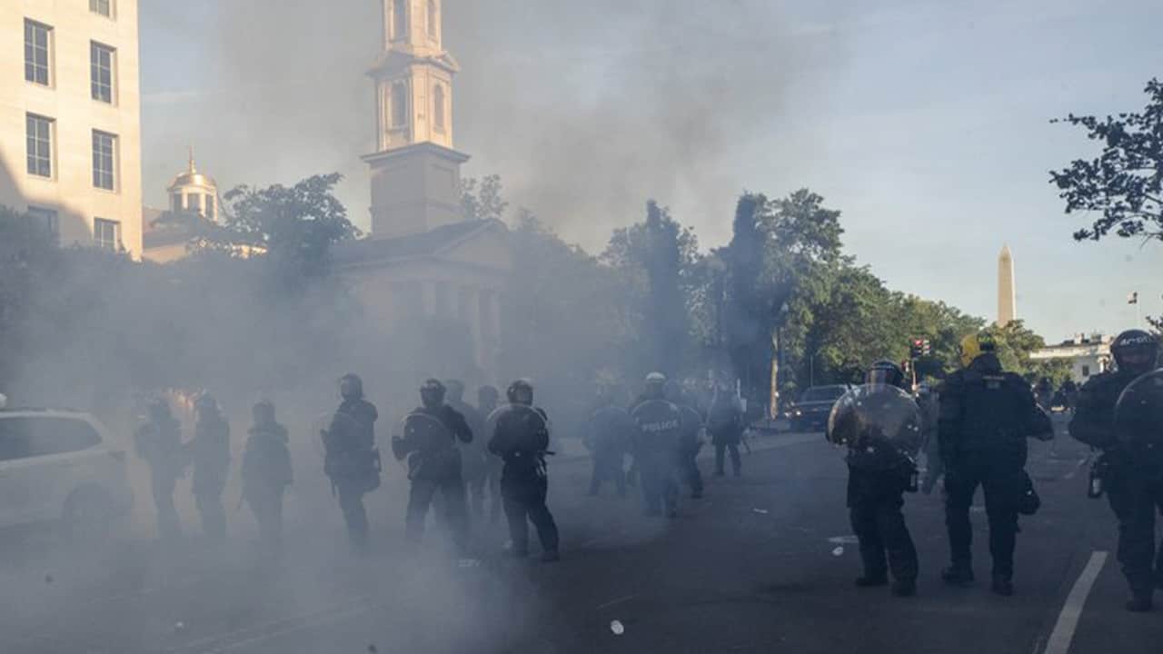 Photo of tear gas floating in the air around officers